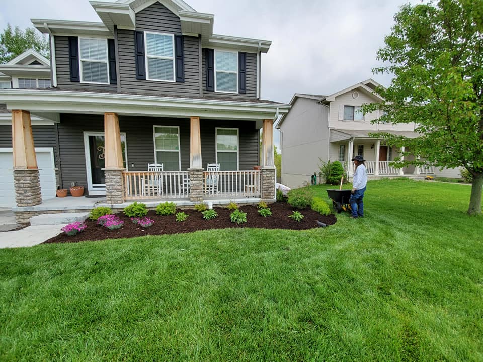 Landscape bed with fresh dark hardwood mulch and clean edging installed by BAM Lawns in Bellevue, NE